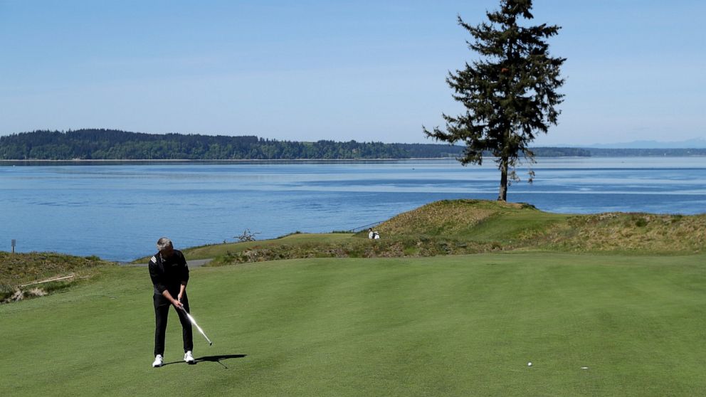 In this May 6, 2019, photo, PGA golf professional Jacob Lippold putts on the third green at Chambers Bay, in University Place, Wash. Four years removed from the U.S. Open golf championship that was largely derided for its putting green problems, Cham