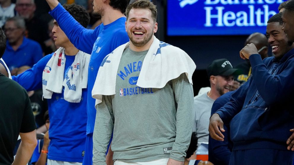 Dallas Mavericks guard Luka Doncic smiles on the bench during the second half of Game 7 of an NBA basketball Western Conference playoff semifinal against the Phoenix Suns, Sunday, May 15, 2022, in Phoenix. The Mavericks defeated the Suns 123-90. (AP 
