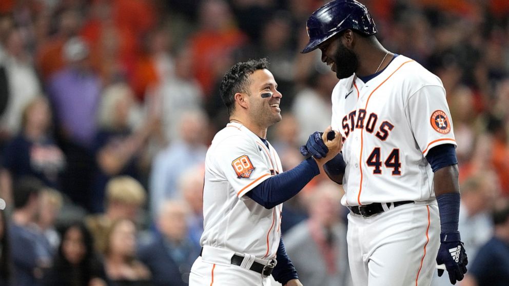 Houston Astros' Yordan Alvarez (44) celebrates with Jose Altuve after hitting a two-run home run against the Los Angeles Angels during the seventh inning of a baseball game Monday, April 18, 2022, in Houston. (AP Photo/David J. Phillip)