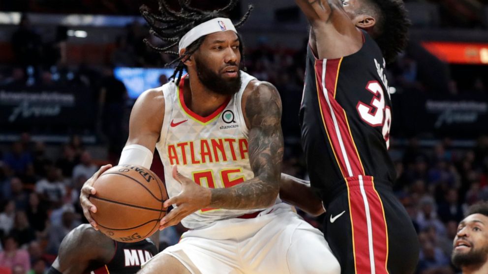 Atlanta Hawks guard DeAndre' Bembry, left, looks to pass as Miami Heat forward Chris Silva (30) defends during the first half of an NBA basketball game, Tuesday, Dec. 10, 2019, in Miami. (AP Photo/Lynne Sladky)