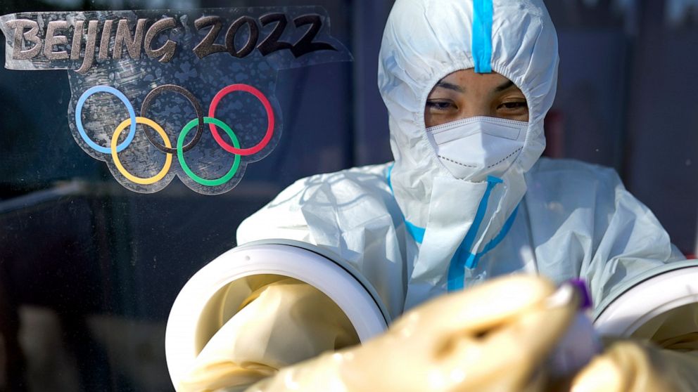 A worker prepares to administer a COVID-19 test at the 2022 Winter Olympics, Tuesday, Feb. 1, 2022, in Beijing. (AP Photo/David J. Phillip)