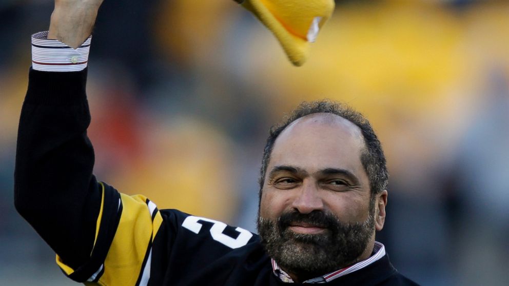 FILE - Pittsburgh Steelers Hall of Fame running back Franco Harris twirls a Terrible Towel during a ceremony commemorating the 40th anniversary of his "Immaculate Reception" catch in the 1972 playoff game against the Oakland Raiders, during the halft