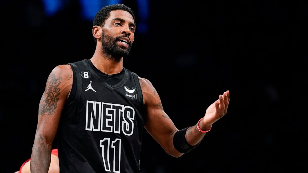 Brooklyn Nets guard Kyrie Irving (11) gestures during the first half of the team's NBA basketball game against the Toronto Raptors on Friday, Dec. 2, 2022, in New York. (AP Photo/Eduardo Munoz Alvarez)
