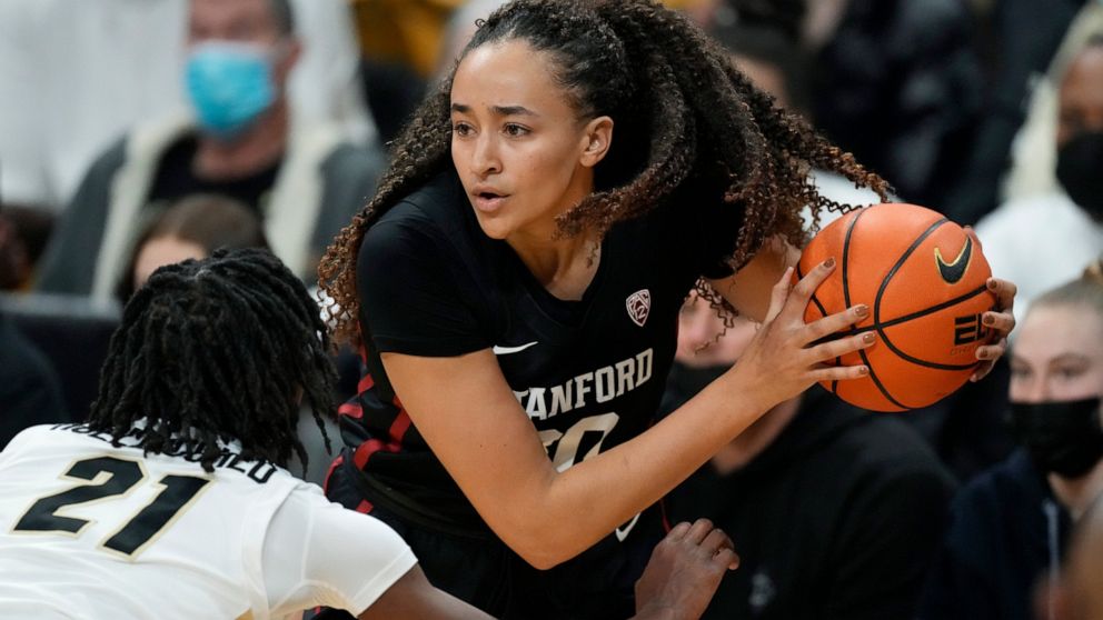 Stanford guard Haley Jones, right, looks to pass the ball as Colorado forward Mya Hollingshed defends in the first half of an NCAA college basketball game Friday, Jan. 14, 2022, in Boulder, Colo. (AP Photo/David Zalubowski)