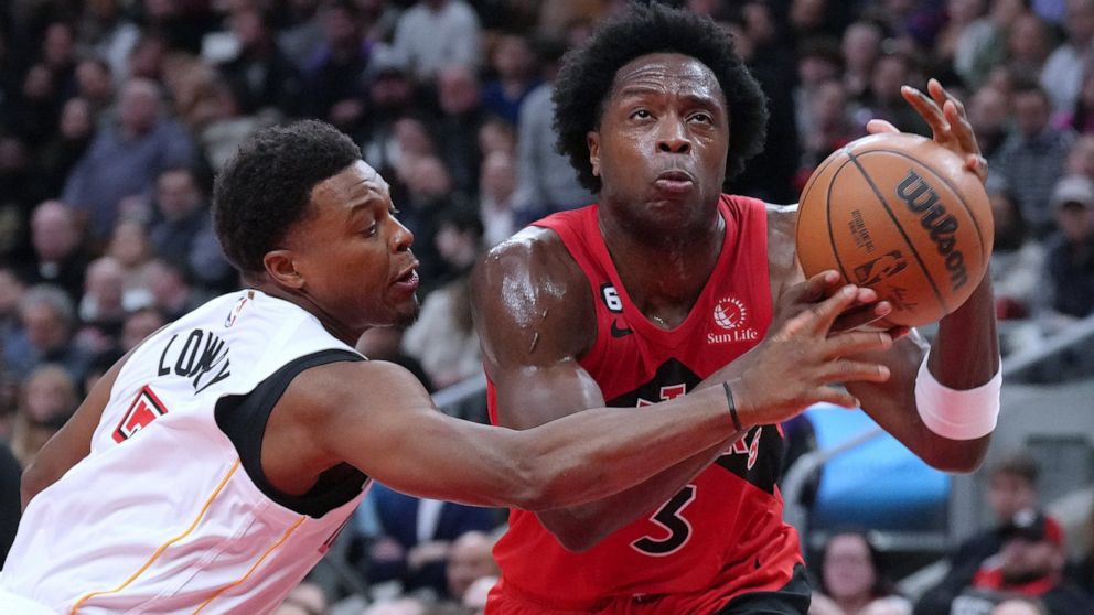 Toronto Raptors' O.G. Anunoby, right, drives past Miami Heat's Kyle Lowry during the first half of an NBA basketball game Wednesday, Nov. 16, 2022, in Toronto. (Chris Young/The Canadian Press via AP)