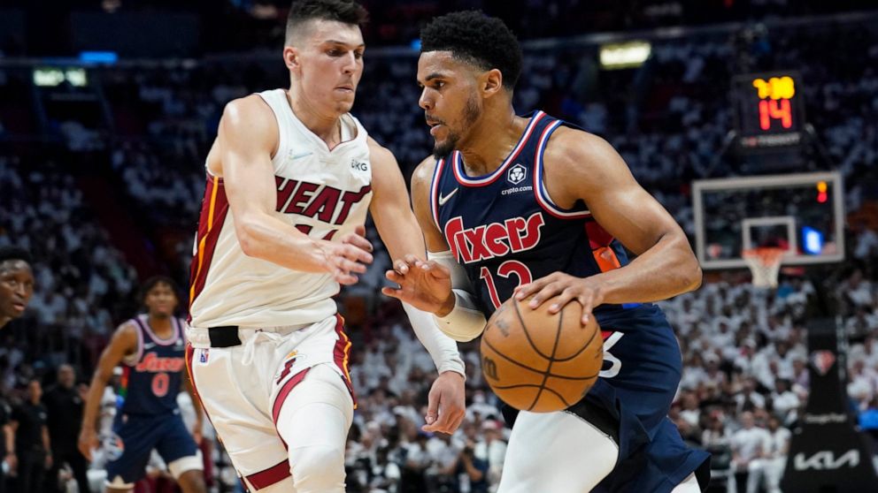 Philadelphia 76ers forward Tobias Harris (12) drives to the basket as Miami Heat guard Tyler Herro (14) defends, during the first half of Game 1 of an NBA basketball second-round playoff series, Monday, May 2, 2022, in Miami. (AP Photo/Marta Lavandier)