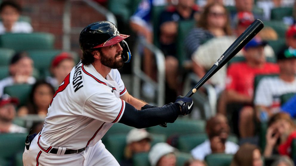Atlanta Braves' Dansby Swanson watches his three-run RBI during the second inning of a baseball game against the St. Louis Cardinals, Monday, July 4, 2022, in Atlanta. (AP Photo/Butch Dill)