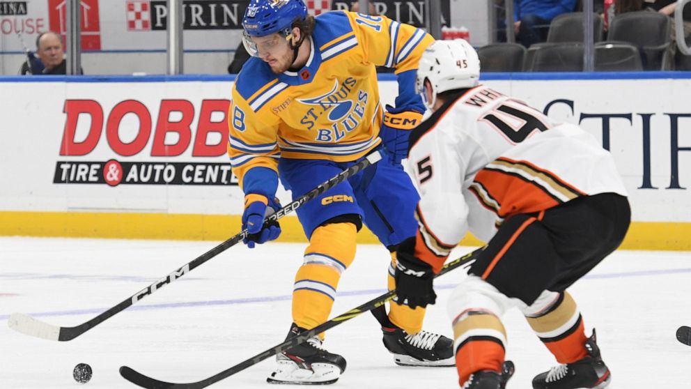 St. Louis Blues' Robert Thomas (18) works the puck against Anaheim Ducks' Colton White (45) during the second period of an NHL hockey game Monday, Nov. 21, 2022, in St. Louis. (AP Photo/Michael Thomas)