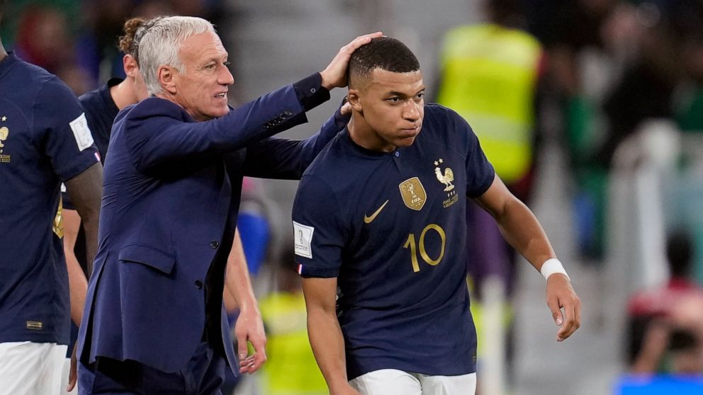 France's head coach Didier Deschamps, left, celebrates a goal by France's Kylian Mbappe, right, during the World Cup round of 16 soccer match between France and Poland, at the Al Thumama Stadium in Doha, Qatar, Sunday, Dec. 4, 2022. (AP Photo/Natacha