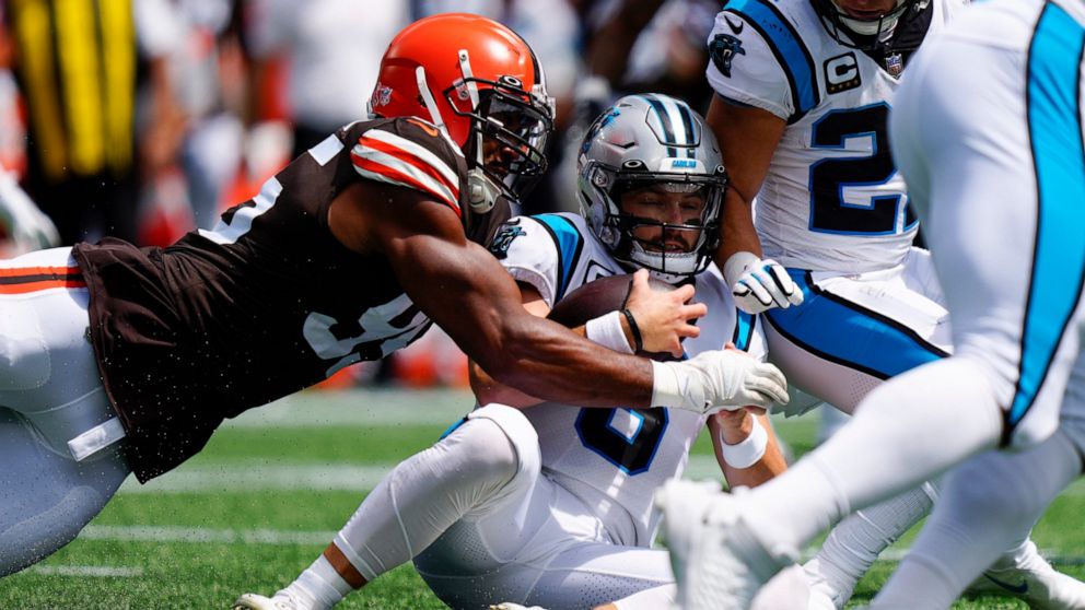 Carolina Panthers quarterback Baker Mayfield is tackled by Cleveland Browns defensive end Myles Garrett after recovering his own fumble during the first quarter of an NFL football game on Sunday, Sept. 11, 2022, in Charlotte, N.C. (AP Photo/Jacob Kup