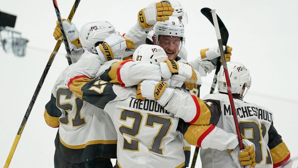 Vegas Golden Knights' Shea Theodore (27) celebrates his goal with teammates during overtime in an NHL hockey game, Tuesday, Nov. 1, 2022, in Washington. The Golden Knights won 3-2. (AP Photo/Patrick Semansky)
