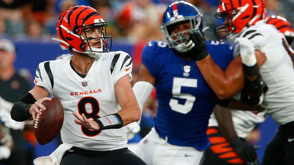 Cincinnati Bengals quarterback Brandon Allen (8) throws a pass as New York Giants' Kayvon Thibodeaux (5) rushes him during the first half of a preseason NFL football game Sunday, Aug. 21, 2022, in East Rutherford, N.J. (AP Photo/John Munson)