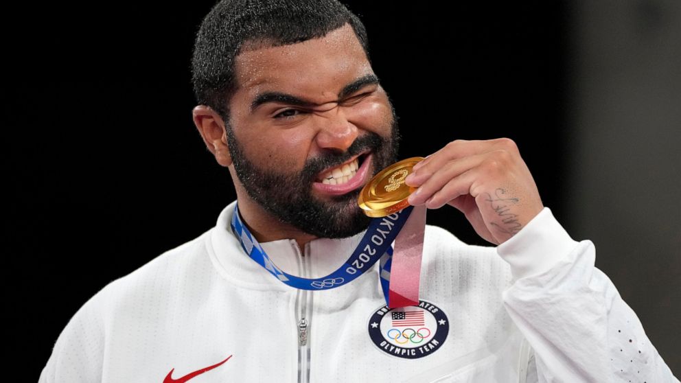 FILE - In this Aug. 6, 2021, file photo, United State's Gable Dan Steveson poses with his gold medal during the medal ceremony for the men's freestyle 125kg wrestling at the 2020 Summer Olympics, in Chiba, Japan. Gable Steveson knew his life had chan