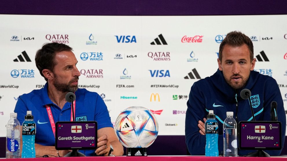 England's head coach Gareth Southgate, left, and Harry Kane speak to the media during a press conference at the Qatar National Convention Center on the eve of the quarterfinal World Cup soccer match between France and England, in Doha, Qatar, Friday,