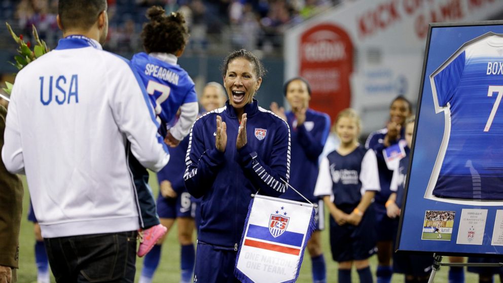 FILE - United States' Shannon Boxx, right, is greeted by her husband Aaron Spearman and their daughter Zoe Spearman, 20 months, before a friendly soccer match Wednesday, Oct. 21, 2015, in Seattle. The match was Boxx's last of her career. Boxx showed 