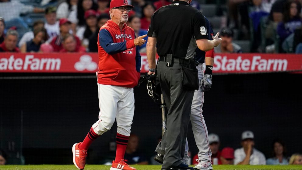 Los Angeles Angels' manager Joe Maddon, left, disputes a stolen base call during the fifth inning of a baseball game against the Boston Red Sox in Anaheim, Calif., Monday, June 6, 2022. (AP Photo/Ashley Landis)