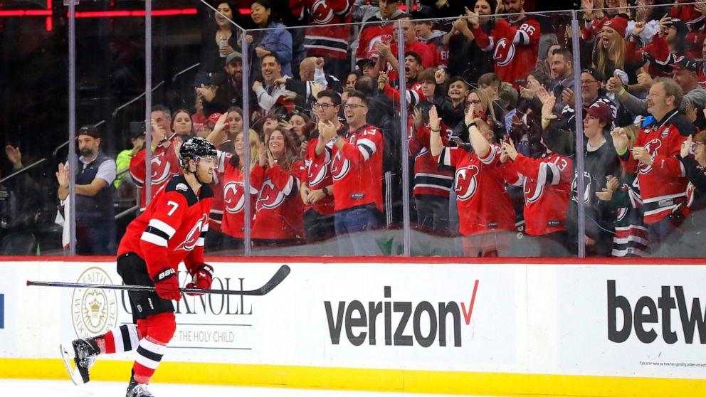 New Jersey Devils defenseman Dougie Hamilton (7) goes to the banch after scoring a goal against the Arizona Coyotes during the second period of an NHL hockey game, Saturday, Nov. 12, 2022, in Newark, N.J. (AP Photo/Noah K. Murray)