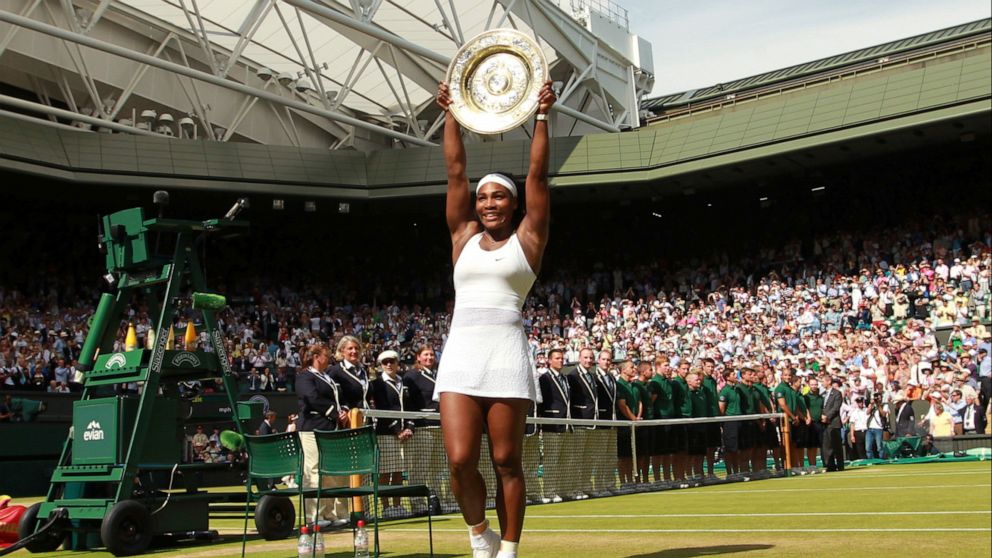 FILE - Serena Williams of the United States holds up the trophy after winning the women's singles final against Garbine Muguruza of Spain at the All England Lawn Tennis Championships in Wimbledon, London, Saturday, July 11, 2015. Chris Evert apprecia