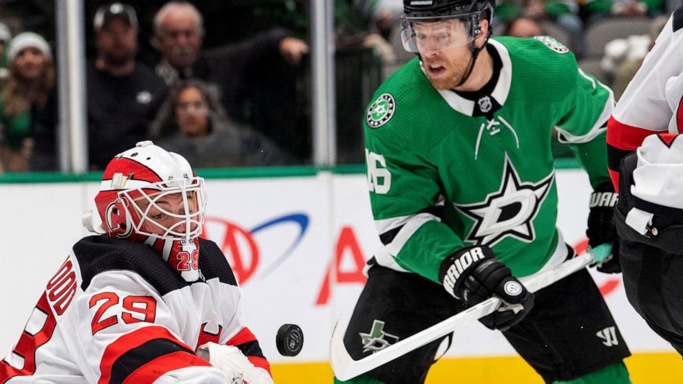 New Jersey Devils goaltender Mackenzie Blackwood (29) deflects the puck as Dallas Stars center Joe Pavelski (16) applies pressure in the first period of an NHL hockey game, Tuesday, Dec. 10, 2019, in Dallas. Pavelski scored Dallas' second goal of the