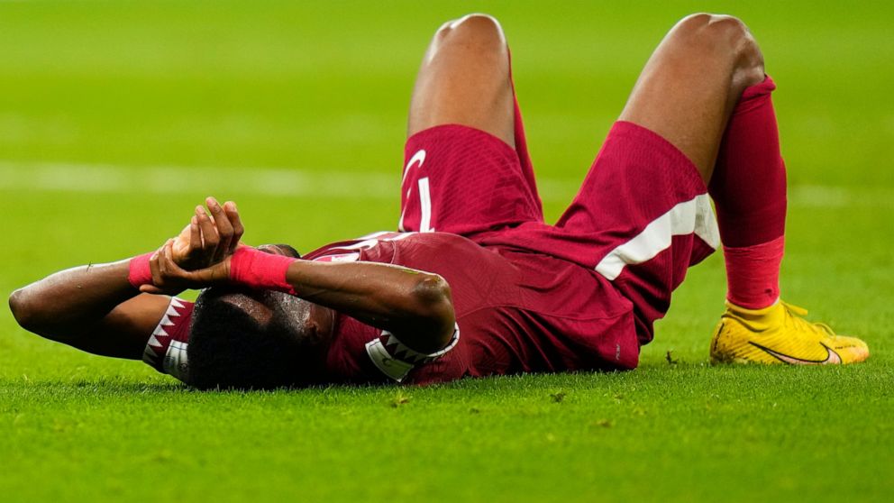 Qatar's Ismail Mohamad lies after his side's 1-3 lost against Senegal during a World Cup group A soccer match at the Al Thumama Stadium in Doha, Qatar, Friday, Nov. 25, 2022. (AP Photo/Petr Josek)