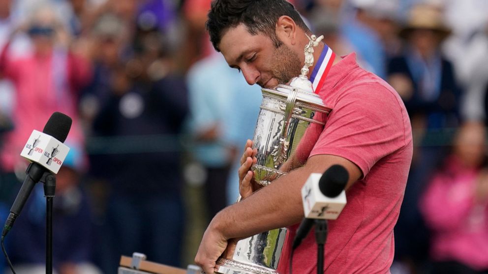 Jon Rahm, of Spain, holds the champions trophy after the final round of the U.S. Open Golf Championship, Sunday, June 20, 2021, at Torrey Pines Golf Course in San Diego. (AP Photo/Gregory Bull)