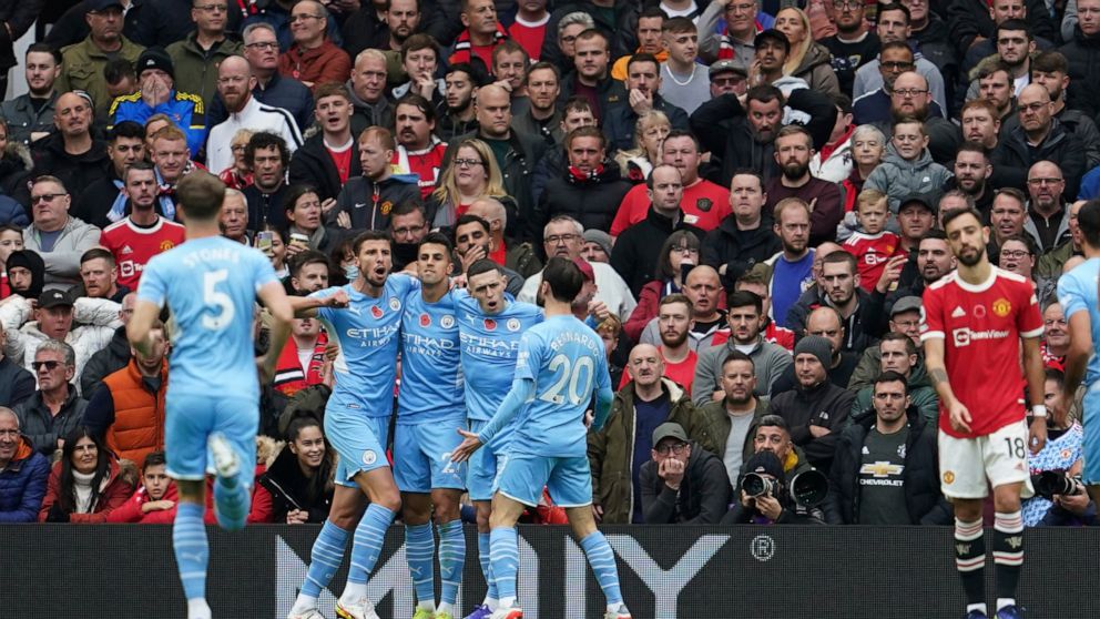 Manchester City players celebrates after Manchester United's Eric Bailly scored an own goal during the English Premier League soccer match between Manchester United and Manchester City at Old Trafford stadium in Manchester, England, Saturday, Nov. 6,