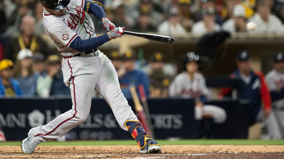 Atlanta Braves' Adam Duvall hits an RBI double during the eighth inning of the team's baseball game against the San Diego Padres in San Diego, Friday, April 15, 2022. (AP Photo/Kyusung Gong)