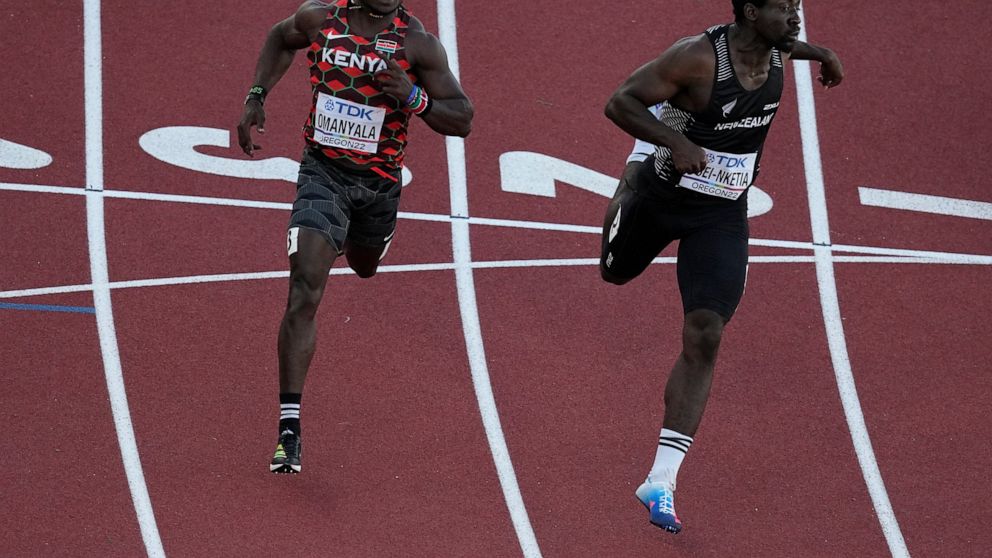 Ferdinand Omanyala, left, of Kenya, runs in a heat of the men's 100-meter run at the World Athletics Championships Friday, July 15, 2022, in Eugene, Ore.(AP Photo/Gregory Bull)