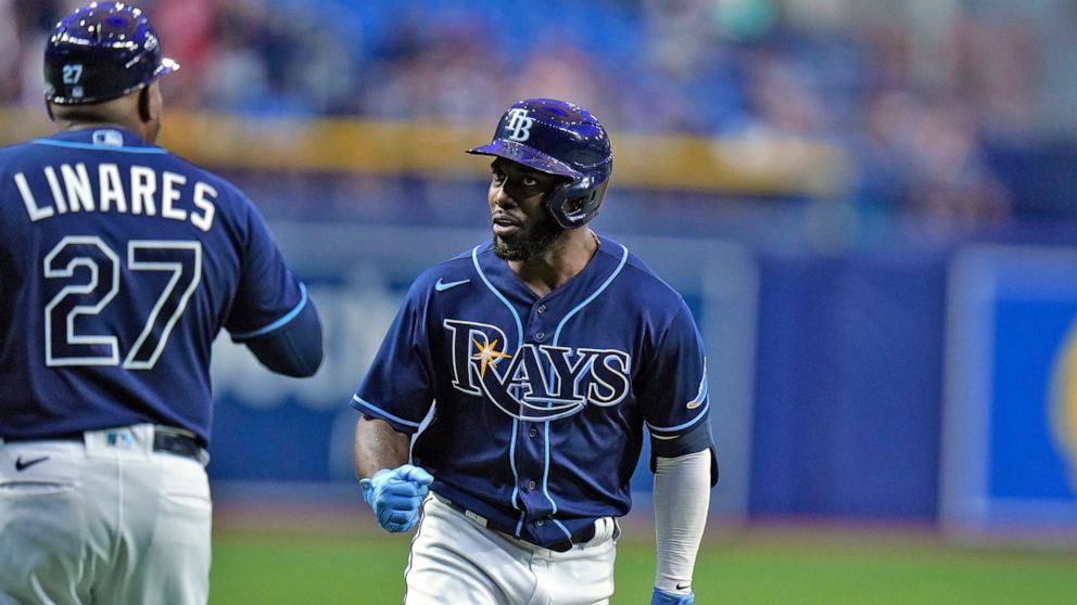 Tampa Bay Rays' Randy Arozarena, right, celebrates with third base coach Rodney Linares (27) after his two-run home run off Chicago White Sox pitcher Davis Martin during the first inning of a baseball game Friday, June 3, 2022, in St. Petersburg, Fla