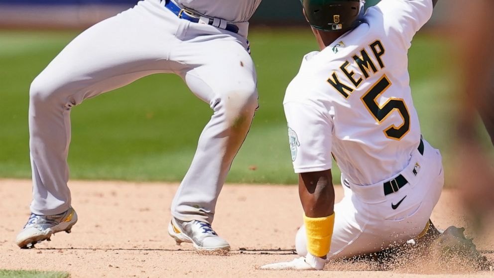 Texas Rangers second baseman Marcus Semien, top, waits for the ball before tagging out Oakland Athletics' Tony Kemp (5) attempting to steal second base during the seventh inning of a baseball game in Oakland, Calif., Sunday, April 24, 2022. (AP Photo