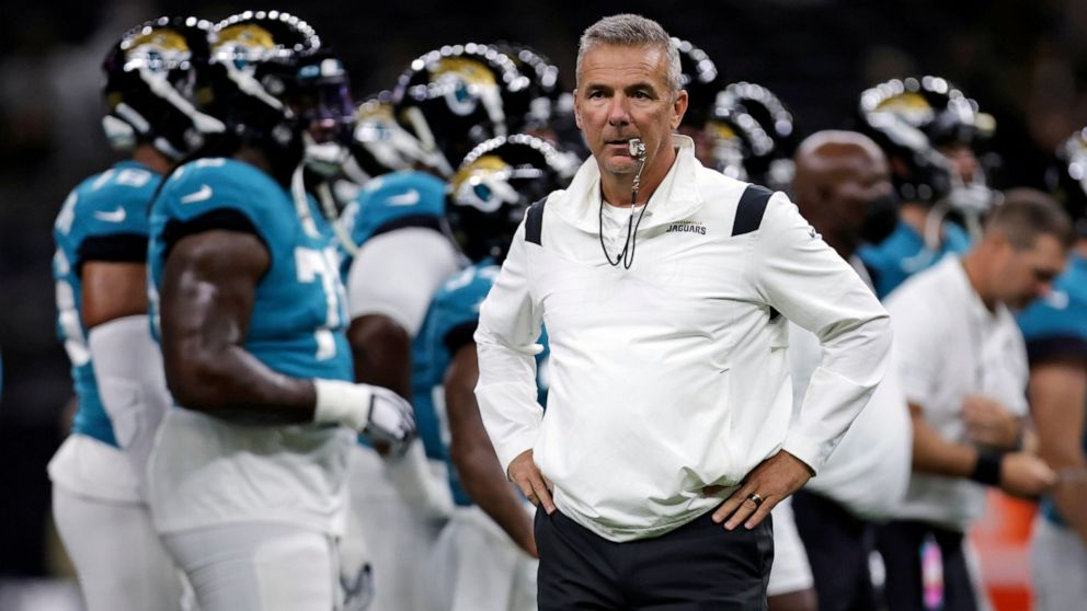 FILE - In this Monday, Aug. 23, 2021, file photo, Jacksonville Jaguars head coach Urban Meyer watches as his team warms up before a preseason NFL = football game against the New Orleans Saints in New Orleans. In many regards, Meyer runs the Jaguars l