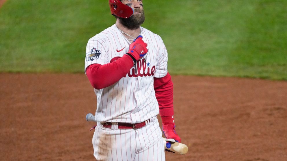 Philadelphia Phillies' Bryce Harper walks to the dugout after striking out during the fourth inning in Game 4 of baseball's World Series between the Houston Astros and the Philadelphia Phillies on Wednesday, Nov. 2, 2022, in Philadelphia. (AP Photo/C