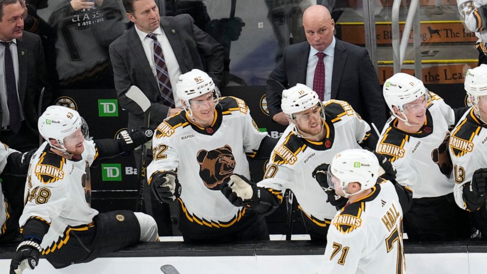 Boston Bruins left wing Taylor Hall (71) is congratulated after his goal against the Tampa Bay Lightning during the third period of an NHL hockey game, Tuesday, Nov. 29, 2022, in Boston. (AP Photo/Charles Krupa)