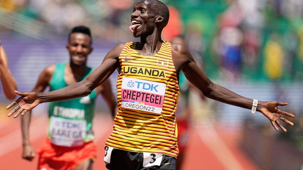 Joshua Cheptegei, of Uganda, reacts to winning the men's 10000-meter run final at the World Athletics Championships on Sunday, July 17, 2022, in Eugene, Ore. (AP Photo/Ashley Landis)