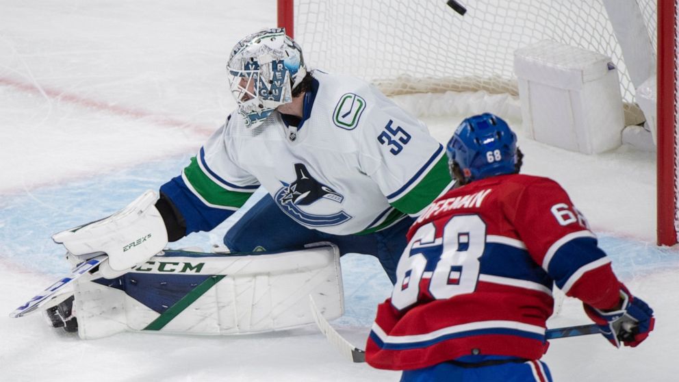 Montreal Canadiens' Mike Hoffman (68) scores past Vancouver Canucks goaltender Thatcher Demko during the second period of an NHL hockey game in Montreal, Wednesday, Nov. 9, 2022. (Graham Hughes/The Canadian Press via AP)
