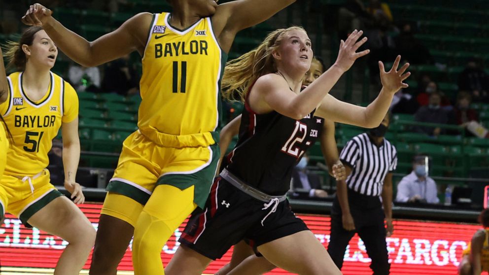 Baylor guard Jordyn Oliver, left, reaches back while battling Texas Tech guard Vivian Gray, right, for a loose rebound in the first half of an NCAA college basketball game, Monday, Dec. 14, 2020, in Waco, Texas. (Rod Aydelotte/Waco Tribune-Herald via AP)