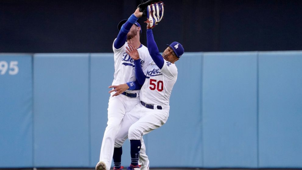 Los Angeles Dodgers right fielder Mookie Betts, right, collides with center fielder Cody Bellinger after making a catch on a ball hit by Los Angeles Angels' Taylor Ward during the first inning of a baseball game Wednesday, June 15, 2022, in Los Angel