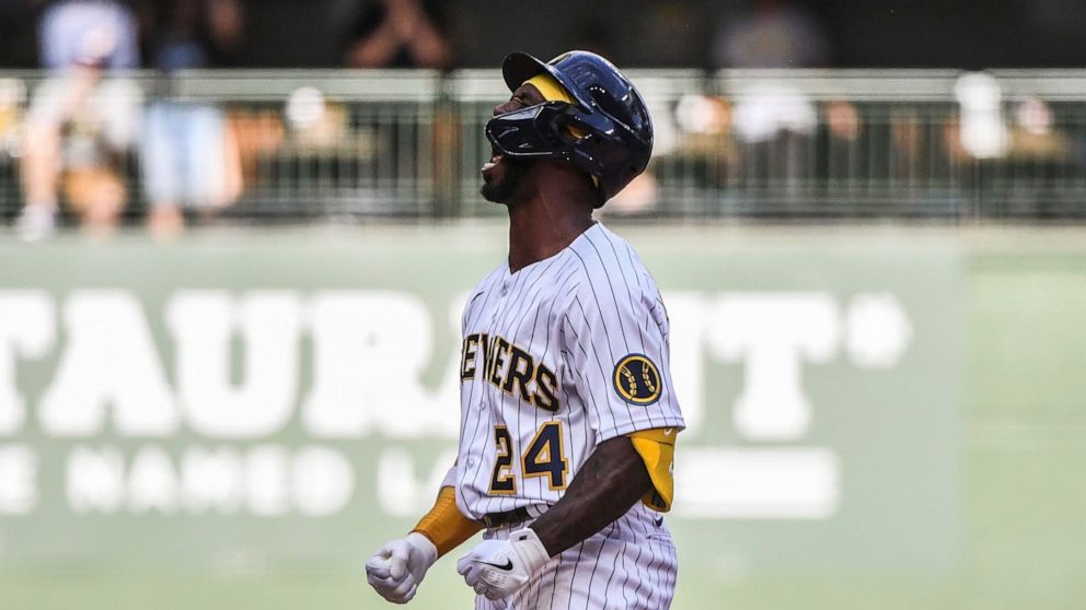 Milwaukee Brewers Andrew McCutchen celebrates his double and putting the Brewers in the lead during the eighth inning of a baseball game against the Colorado Rockies Sunday, July 24, 2022, in Milwaukee. (AP Photo/Kenny Yoo)
