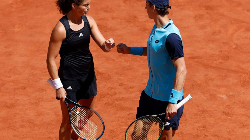 Belgium's Joran Vliegen, right, and Norway's Ulrikke Eikeri check as the play Japan's Ena Shibahara and Netherlands' Wesley Koolhof during their Mixed Doubles final of the French Open tennis tournament at the Roland Garros stadium Thursday, June 2, 2