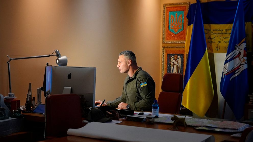 Kyiv Mayor Vitali Klitschko works at his desk in his City Hall office in the Ukrainian capital, Friday, Nov. 18, 2022. Once a boxing champion, Kyiv's mayor is up against a challenge bigger than any he faced in the ring: Keeping Ukraine’s war-time cap