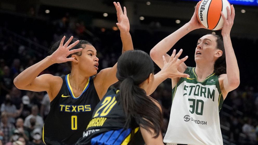 Seattle Storm forward Breanna Stewart (30) puts up a shot against Dallas Wings forward Satou Sabally (0) and guard Briann January (20) during the first half of a WNBA basketball game, Tuesday, July 12, 2022 in Seattle. (AP Photo/Ted S. Warren)
