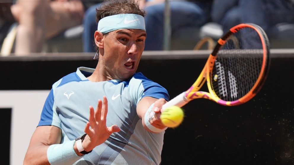 Rafael Nadal returns the ball to John Isner during their match at the Italian Open tennis tournament, in Rome, Wednesday, May 11, 2022. (AP Photo/Andrew Medichini)