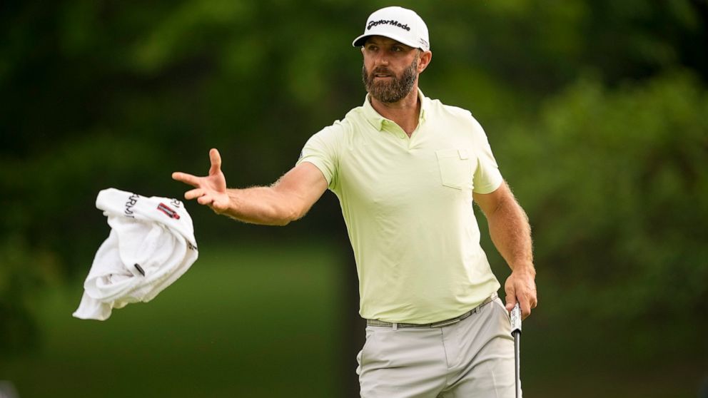 Dustin Johnson tosses his towel to his caddie on the 10th hole during the second round of the PGA Championship golf tournament at Southern Hills Country Club, Friday, May 20, 2022, in Tulsa, Okla. (AP Photo/Matt York)