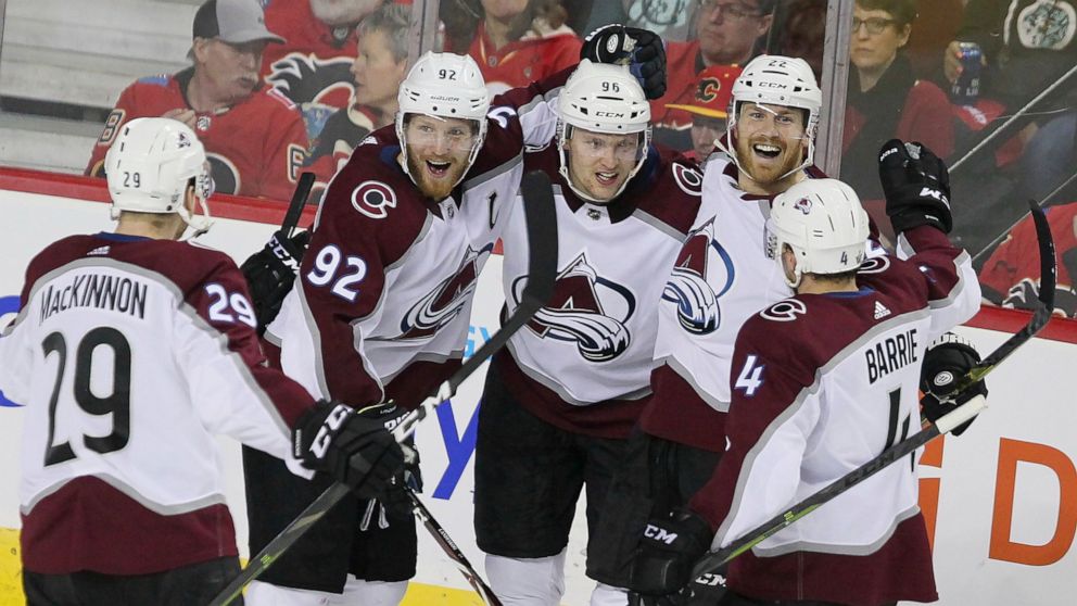 Colorado Avalanche right wing Mikko Rantanen (96) celebrates his goal against the Calgary Flames with teammates Nathan MacKinnon (29), Gabriel Landeskog (92), Colin Wilson (22) and Tyson Barrie (4) during the third period of Game 5 of an NHL hockey f