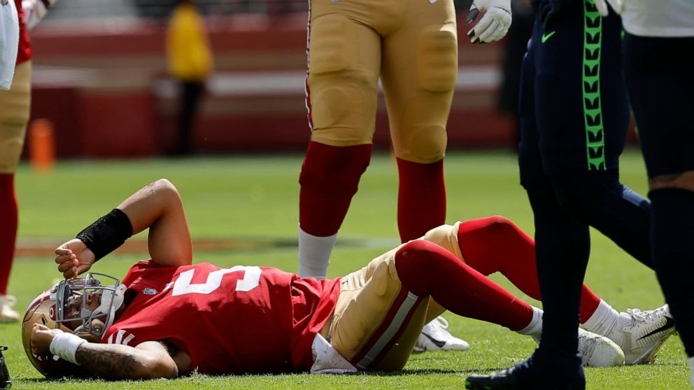 San Francisco 49ers quarterback Trey Lance (5) lies on the field after being tackled during the first half of an NFL football game against the Seattle Seahawks in Santa Clara, Calif., Sunday, Sept. 18, 2022. (AP Photo/Josie Lepe)