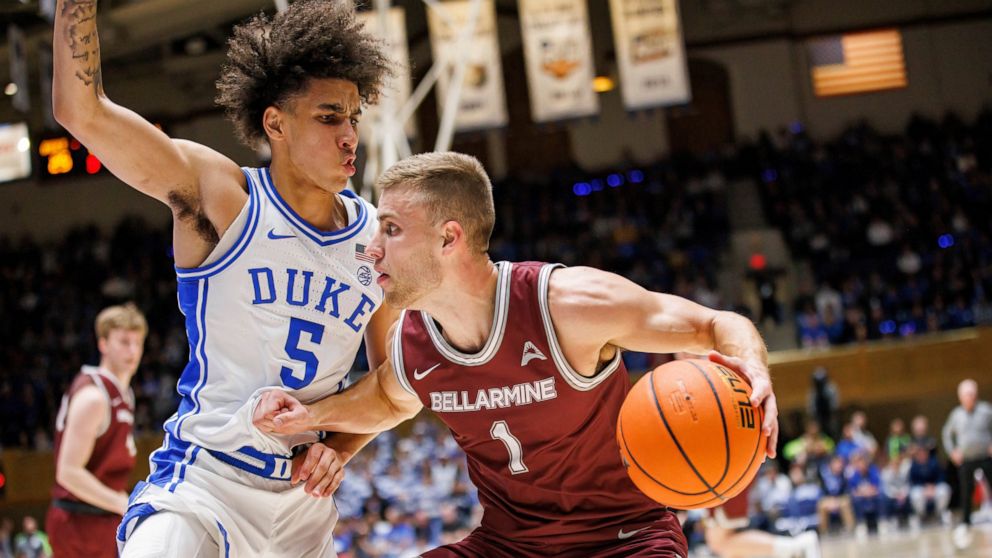 Bellarmine's Juston Betz (1) handles the ball as Duke's Tyrese Proctor (5) defends during the first half of an NCAA college basketball game in Durham, N.C., Monday, Nov. 21, 2022. (AP Photo/Ben McKeown)