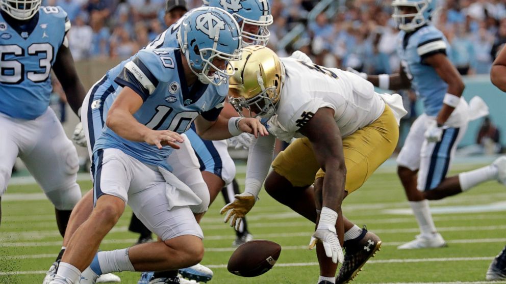 North Carolina quarterback Drake Maye (10) fumbles the ball and Notre Dame defensive lineman Justin Ademilola (9), right, recovers it during the second half of an NCAA college football game in Chapel Hill, N.C., Saturday, Sept. 24, 2022. (AP Photo/Ch