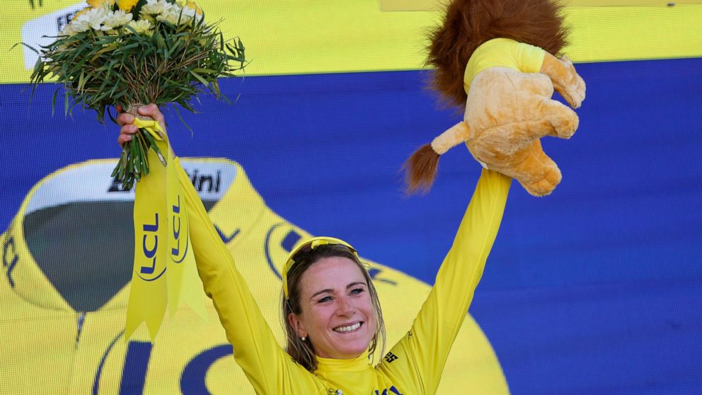 Netherland's Annemiek Van Vleuten, wearing the overall leader's yellow jersey, celebrates on the podium after winning the Tour de France women's cycling race, in La Super Planche des Belles Filles, eastern France, Sunday, July 31, 2022. (AP Photo/Jea
