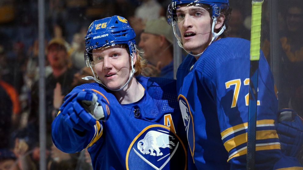 Buffalo Sabres defenseman Rasmus Dahlin (26) and right wing Tage Thompson (72) celebrate a goal by Dahlin during the second period of an NHL hockey game against the Philadelphia Flyers on Saturday, April. 16, 2022, in Buffalo, N.Y. (AP Photo/Joshua B
