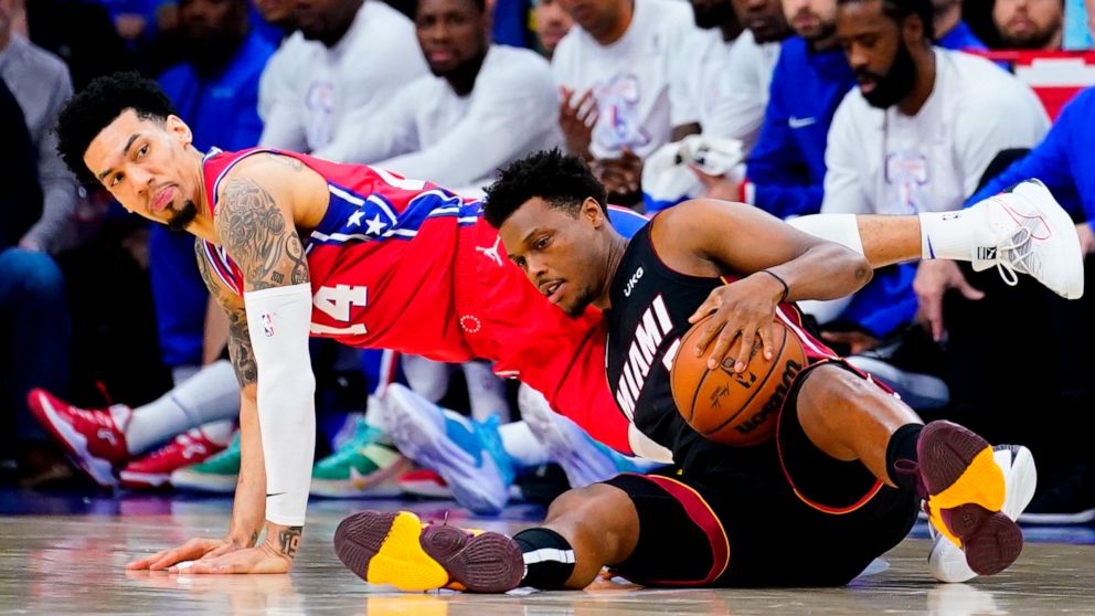 Miami Heat's Kyle Lowry, right, and Philadelphia 76ers' Danny Green battle for the ball during the second half of Game 4 of an NBA basketball second-round playoff series, Sunday, May 8, 2022, in Philadelphia. (AP Photo/Matt Slocum)